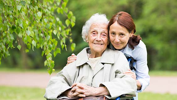 Older woman in a wheelchair and her daughter